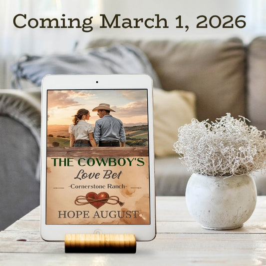 Wholesome cowboy romance novel. Tablet displaying a book cover with a couple in a field, placed on a table with a vase in the background.